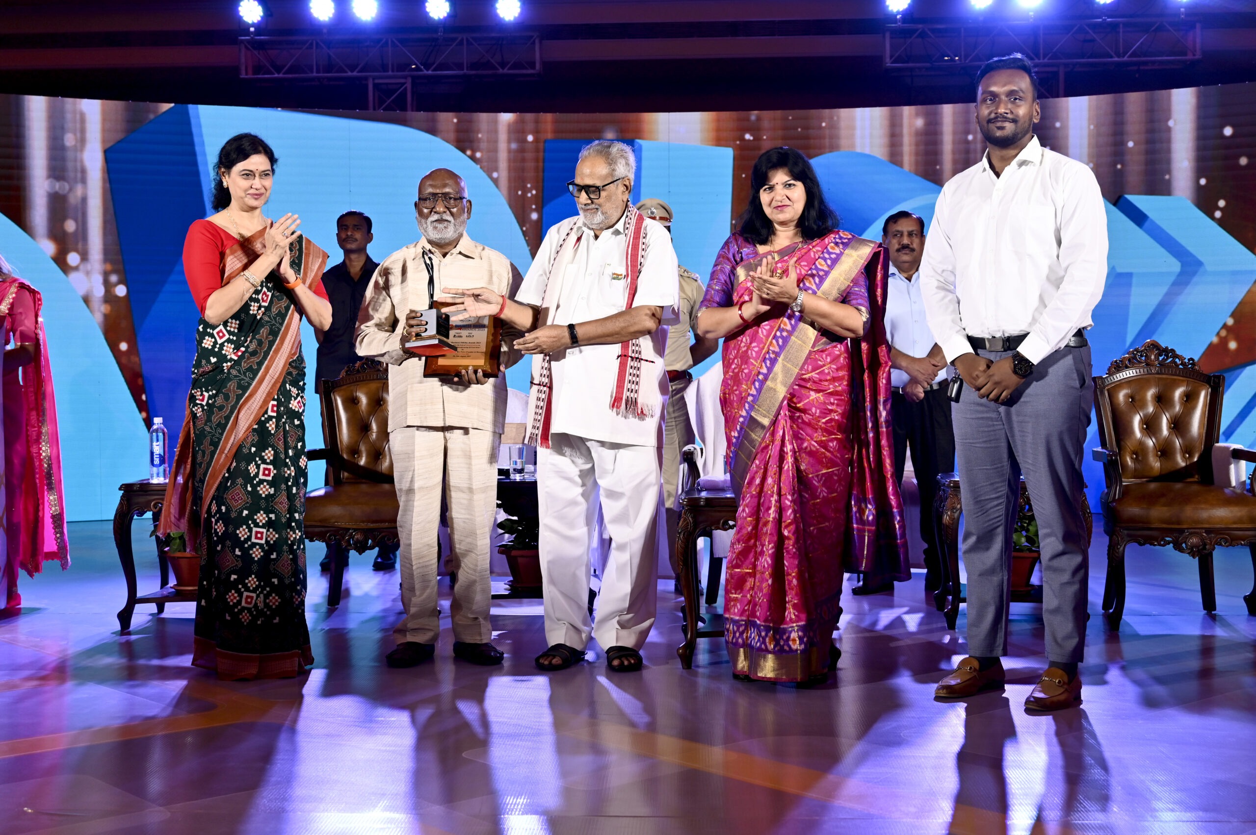 Kasturi Food Products award event — founders with award trophy at OTV Business Odisha ceremony